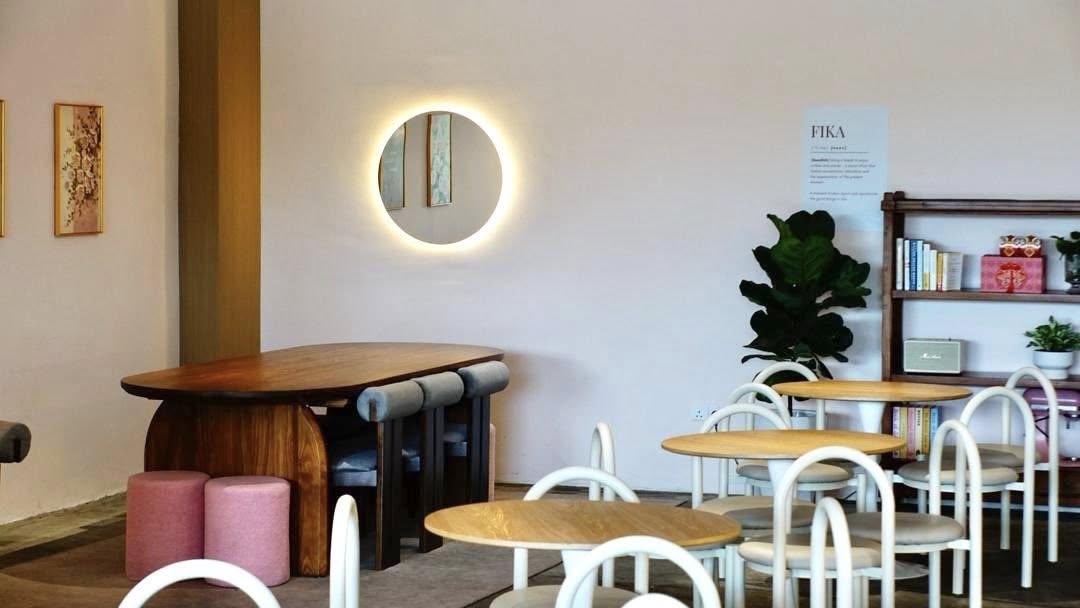 Fika café interior with circular mirror and warm lighting