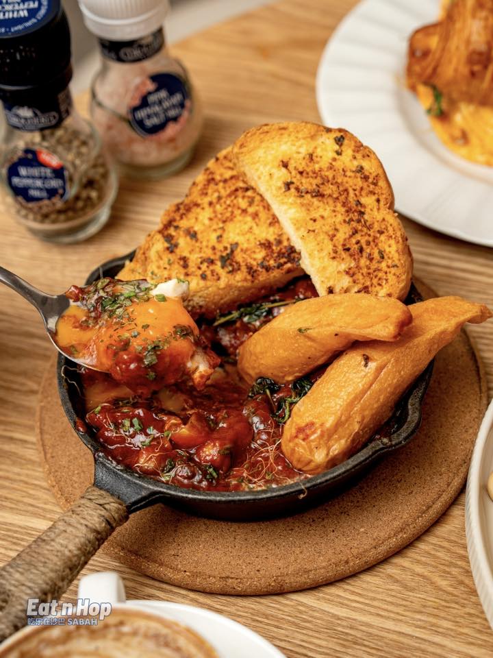 Shakshuka in cast iron skillet with toast